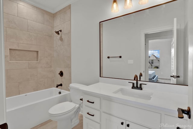 full bathroom with vanity, toilet, and tiled shower / bath