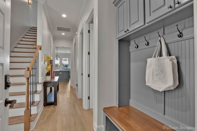 mudroom featuring light hardwood / wood-style flooring, a chandelier, and crown molding