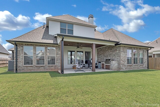 back of property with a yard, ceiling fan, central AC, and a patio area