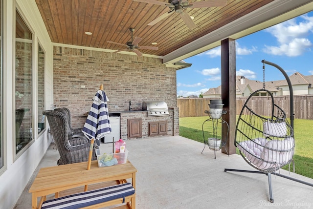 view of patio with area for grilling, grilling area, and ceiling fan