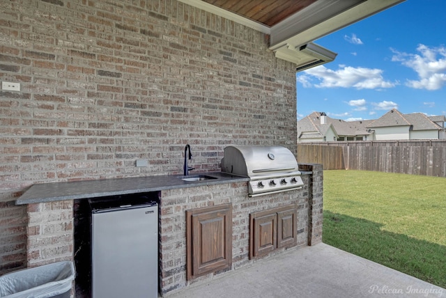 view of patio featuring area for grilling and sink