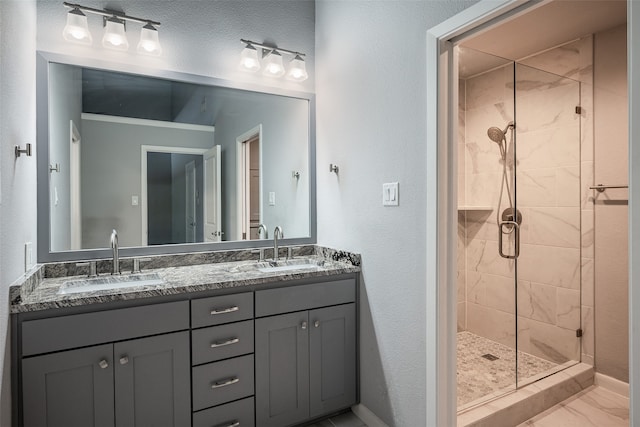 bathroom with a textured ceiling, walk in shower, and vanity