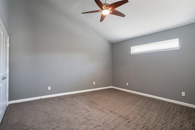 empty room with ceiling fan and vaulted ceiling