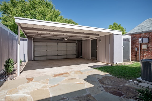 garage featuring a carport and central air condition unit