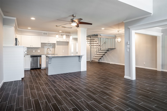 kitchen with white cabinets, dishwasher, ceiling fan, ornamental molding, and dark hardwood / wood-style floors