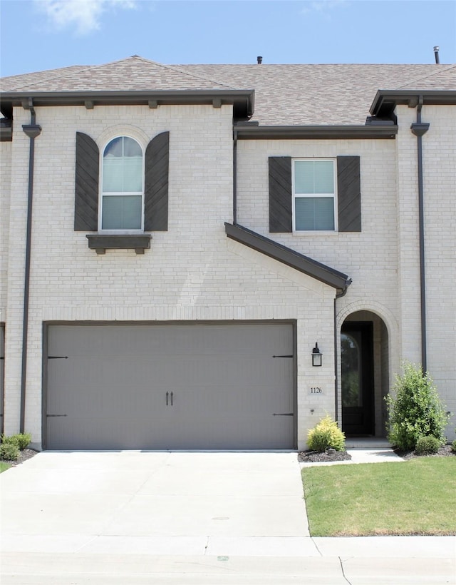 view of front of property with concrete driveway and brick siding