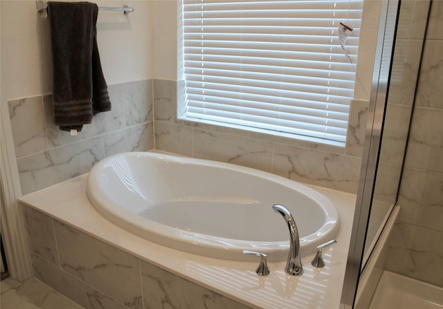 bathroom with tiled tub