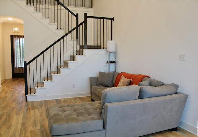 living room with hardwood / wood-style flooring and a chandelier