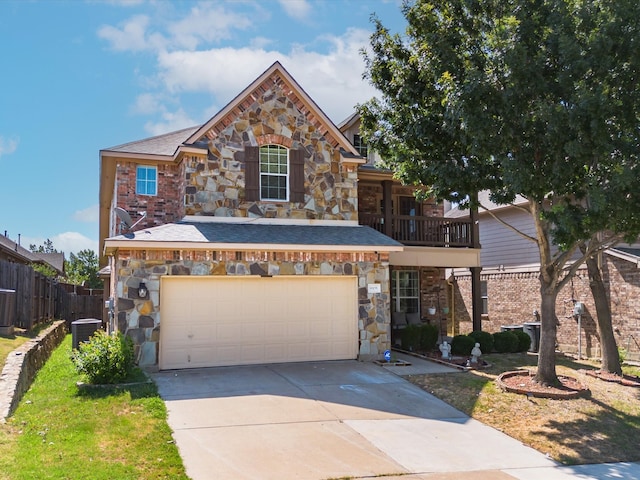 view of property featuring a balcony, a garage, and central AC unit