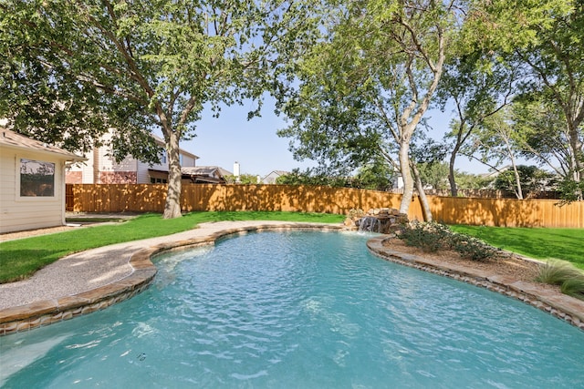 view of swimming pool featuring a yard and pool water feature