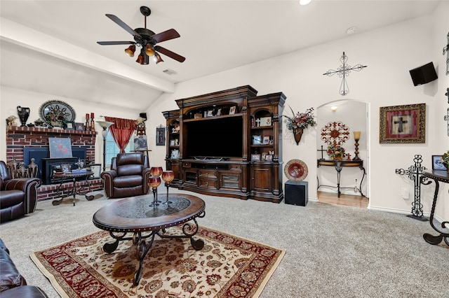 carpeted living room featuring vaulted ceiling with beams, ceiling fan, visible vents, and baseboards