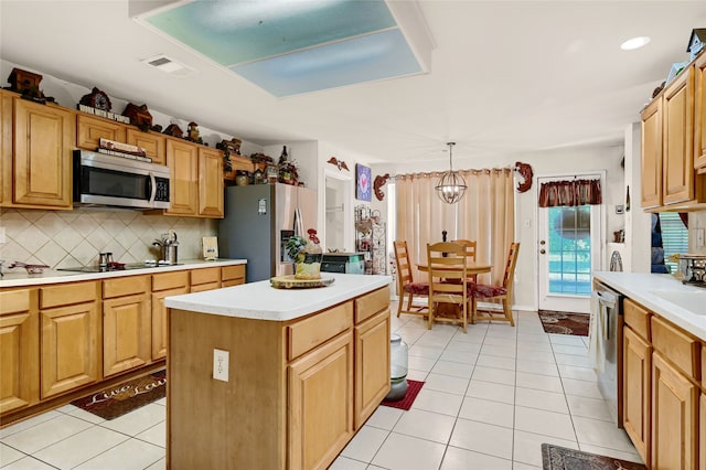 kitchen featuring light tile patterned floors, tasteful backsplash, light countertops, visible vents, and appliances with stainless steel finishes