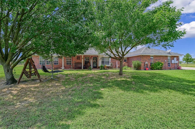 ranch-style home featuring brick siding and a front yard