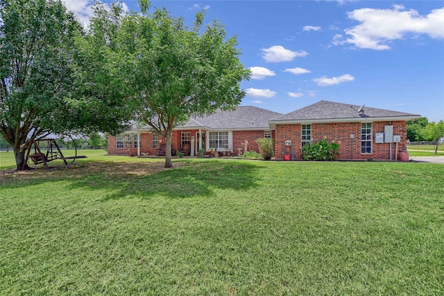 view of front of home with a front lawn and brick siding