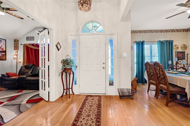 entrance foyer with a ceiling fan, lofted ceiling, and hardwood / wood-style floors