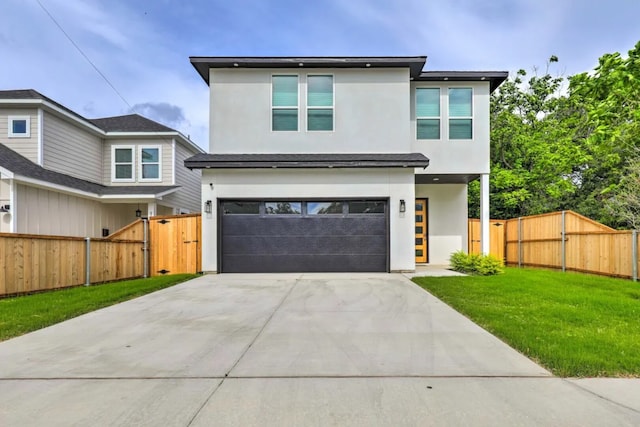 view of front of house featuring a front yard and a garage