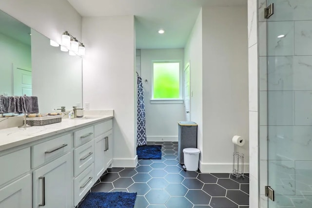 bathroom featuring tile patterned flooring, vanity, and a shower with shower door