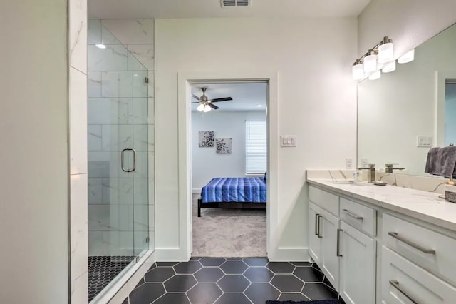 bathroom with tile patterned flooring, vanity, ceiling fan, and a shower with shower door