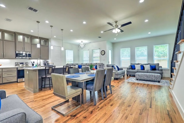 dining area with ceiling fan and light wood-type flooring