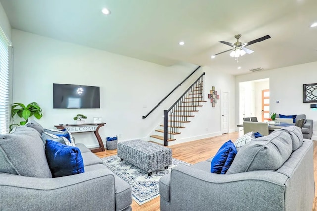 living room featuring ceiling fan and light wood-type flooring