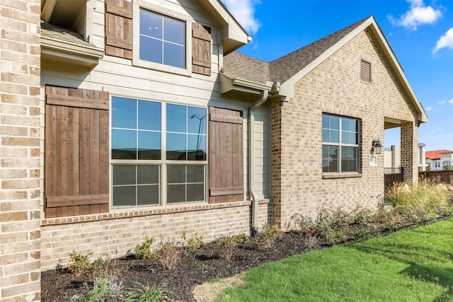 view of side of home with a yard