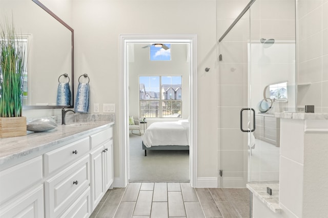 bathroom featuring vanity and an enclosed shower