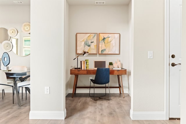 office area with light hardwood / wood-style floors