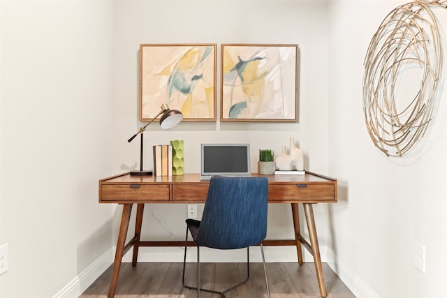 home office with dark hardwood / wood-style floors