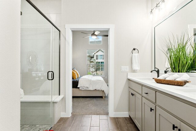 bathroom featuring vanity, a shower with door, and ceiling fan