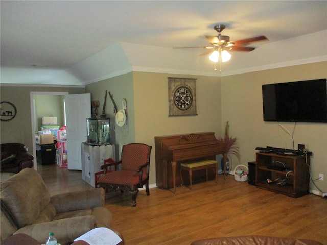 living room featuring ceiling fan, lofted ceiling, and hardwood / wood-style flooring