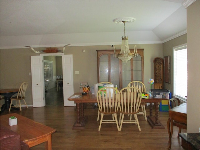 dining area with vaulted ceiling, dark wood-type flooring, ornamental molding, and a notable chandelier