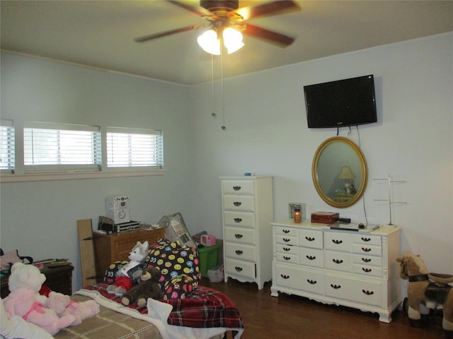 bedroom featuring ceiling fan, dark hardwood / wood-style floors, and crown molding