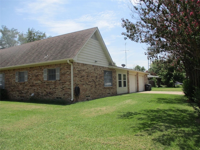 view of home's exterior featuring a lawn and a garage