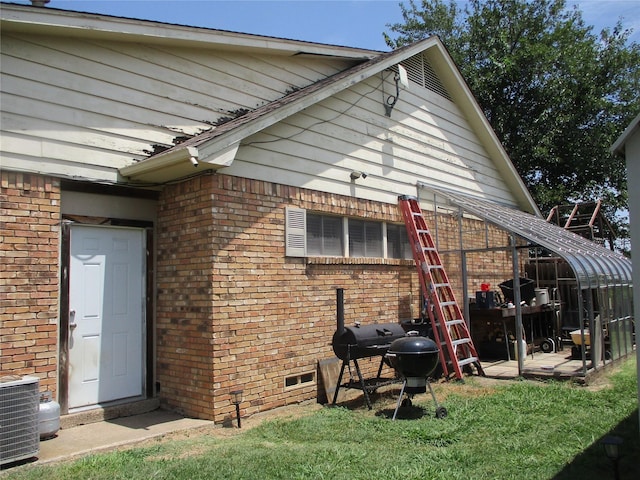 rear view of house featuring central AC