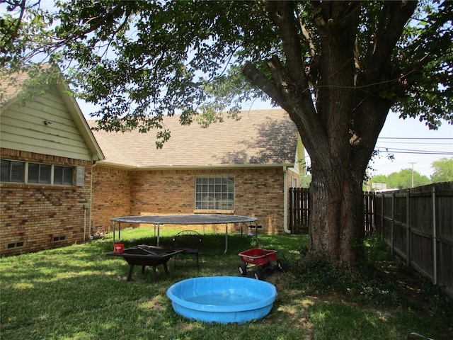 view of yard with a trampoline