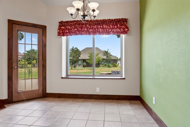 interior space with light tile patterned floors and an inviting chandelier