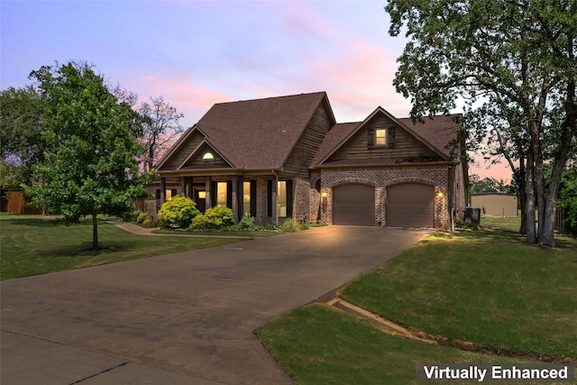 view of front of home featuring a garage, driveway, brick siding, and a front yard