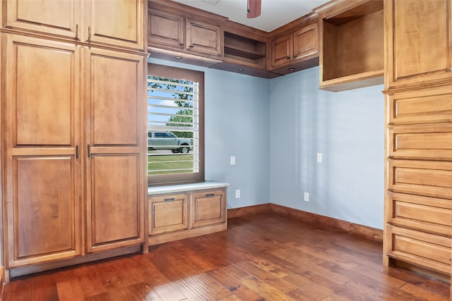 kitchen with ceiling fan and dark hardwood / wood-style flooring