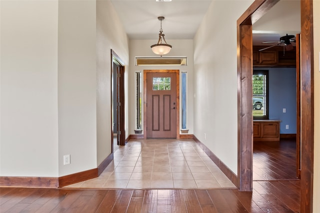 foyer entrance featuring light tile patterned flooring, ceiling fan, and a wealth of natural light