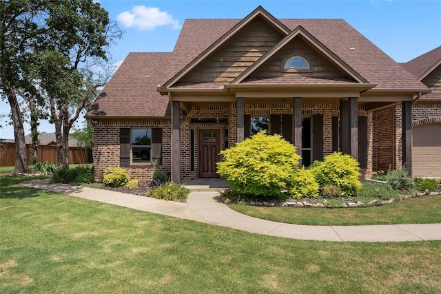 craftsman inspired home with a garage and a front yard