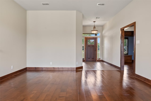 entryway with dark tile patterned flooring