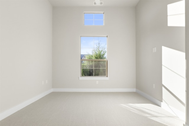 unfurnished room featuring light colored carpet