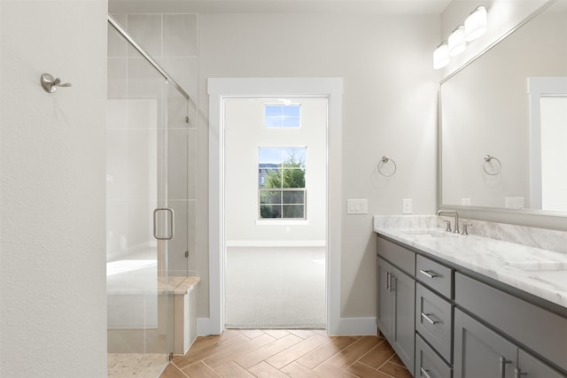 bathroom featuring vanity and a shower with door