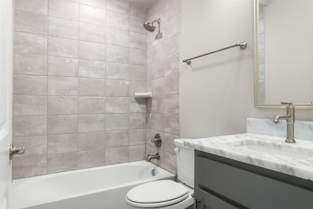 full bathroom with vanity, tiled shower / bath combo, and toilet