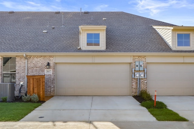 view of front of house with central AC and a garage