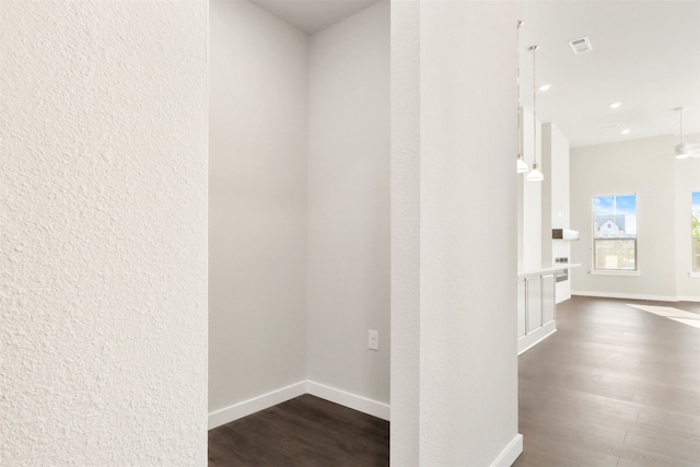 corridor with recessed lighting, baseboards, visible vents, and dark wood-type flooring