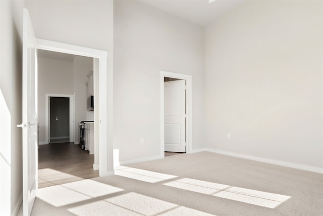 unfurnished bedroom with baseboards and carpet