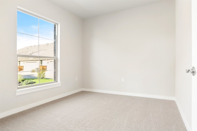 empty room with carpet floors and baseboards