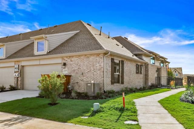 view of property exterior featuring a lawn, a garage, brick siding, fence, and concrete driveway