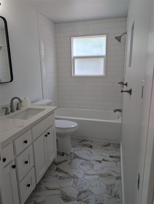 full bathroom with vanity, toilet, and tiled shower / bath combo